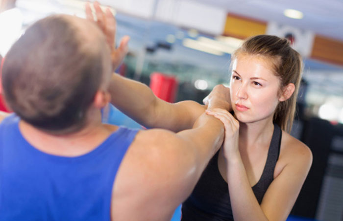 selfdefense photo of woman defending herself by hitting a man in the face