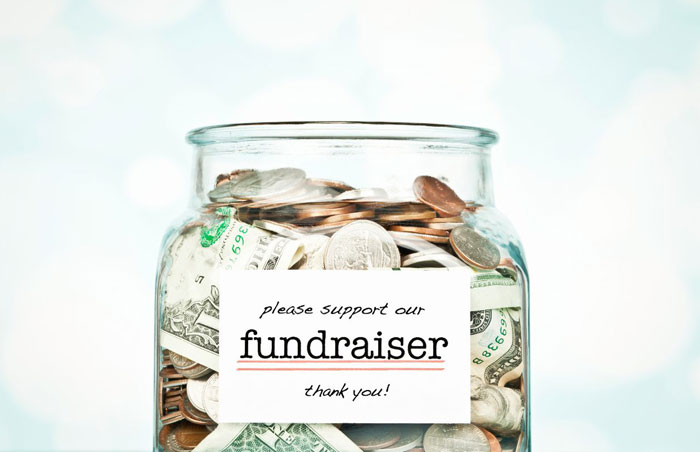 fundraiser photo of a jar filled with money with the word fundraiser on the front
