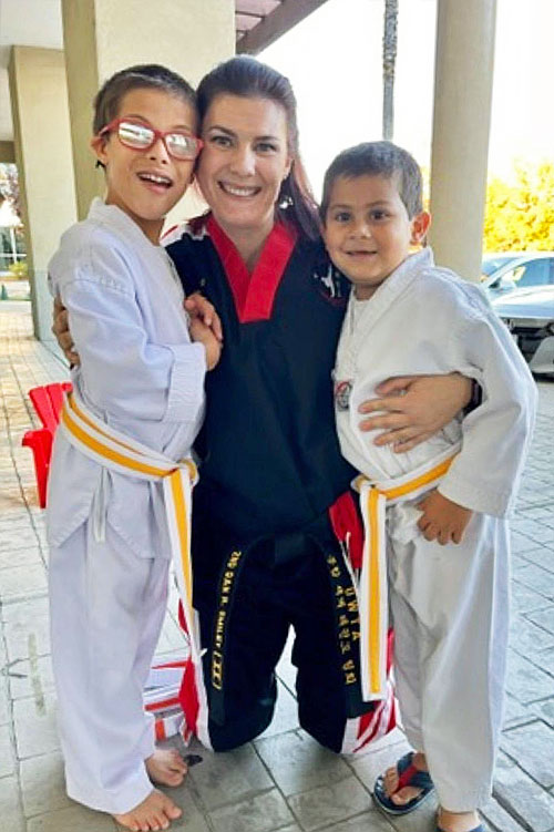 adaptive martial arts instructor with two young students