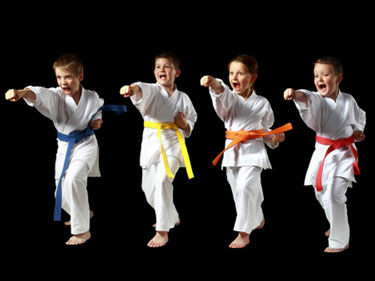 four taekwondo kids doing a punch