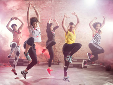 five women in workout gear participating in a zumba class