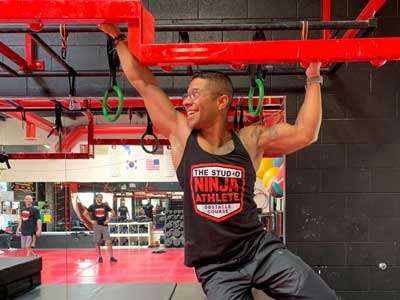 adult-ninja Coach Jose Gomez on the ninja obstacle course at THE STUDIO